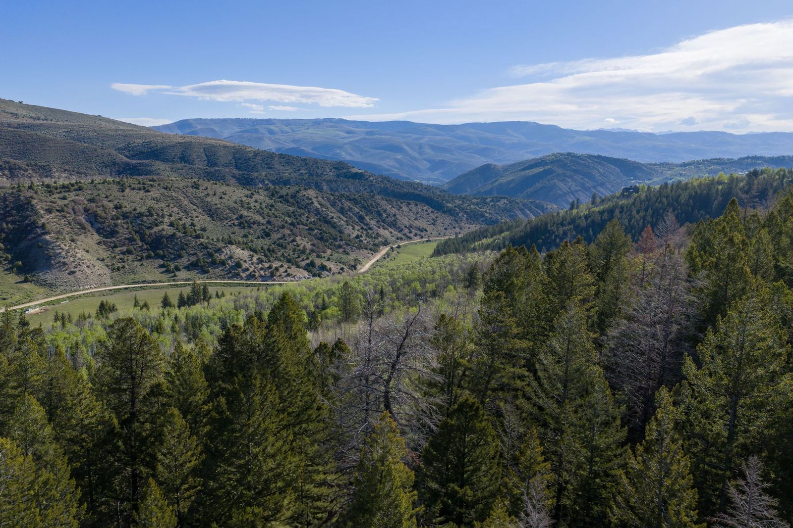 View over the homesites at 370 and 398 Peregrine Drive toward the Vail Valley